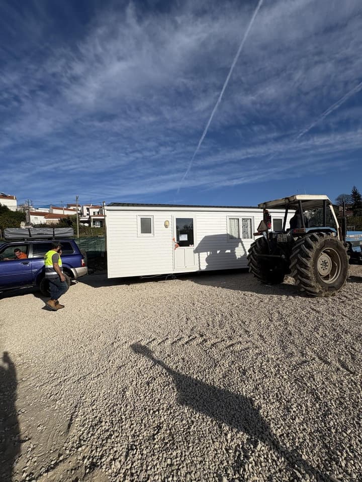 Tractor positioning mobile home on terrain